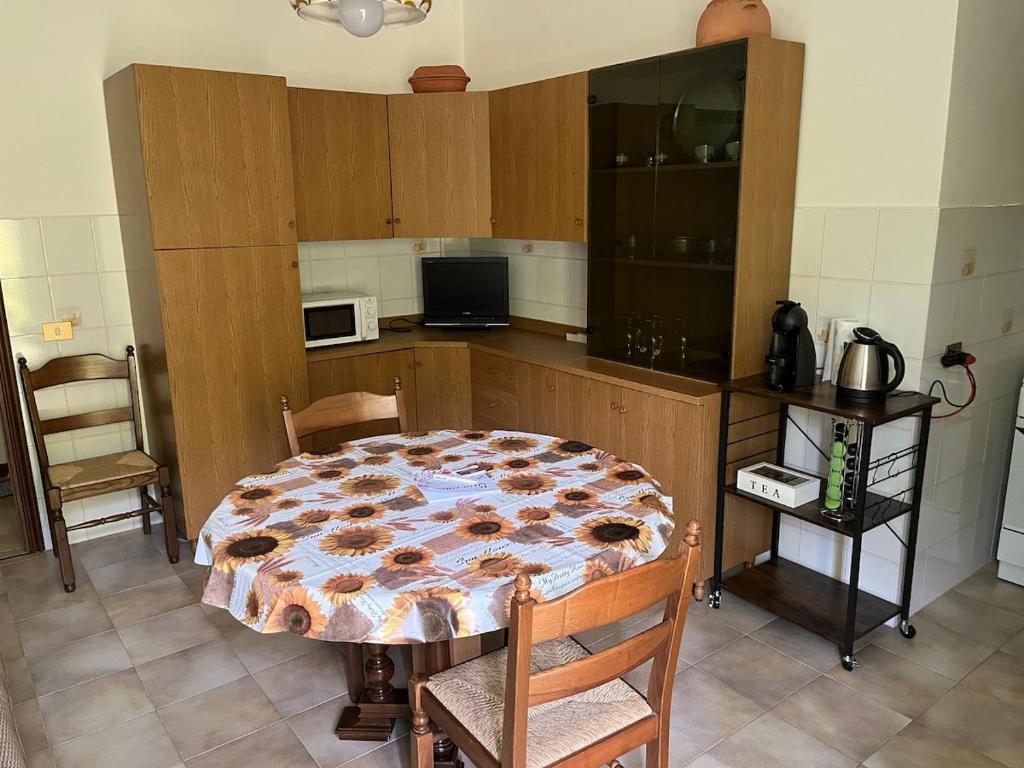 a kitchen with a table in the middle of it at Casa Vacanze ai Valentini in Castelletto Soprano