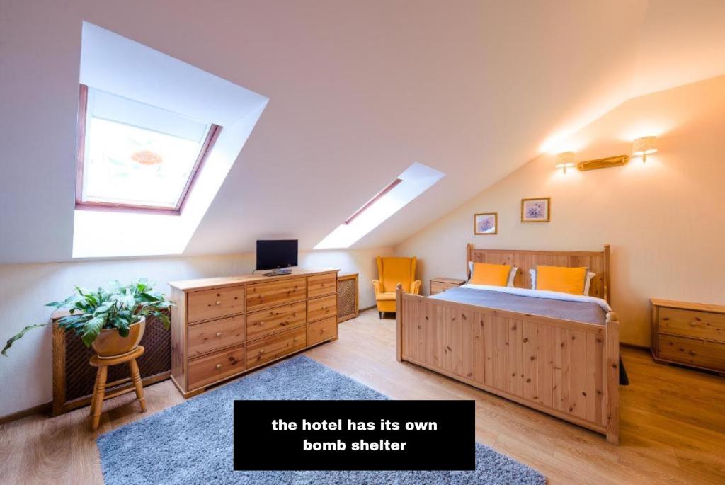 a attic bedroom with a bed and a skylight at Khreschatyk Suites in Kyiv
