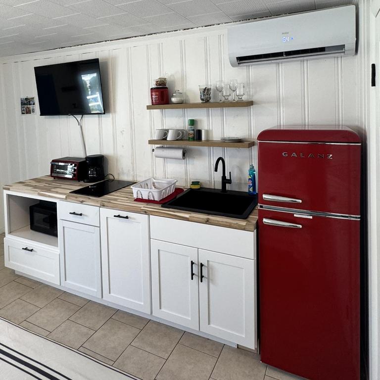 a kitchen with a red refrigerator and a sink at North Beach Motel in Hampton