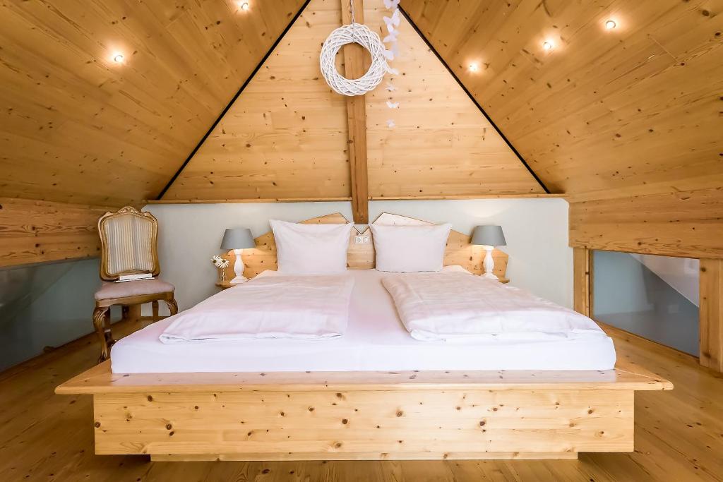a bed in a room with a wooden ceiling at Hotel Zum grünen Kranz in Zell an der Mosel