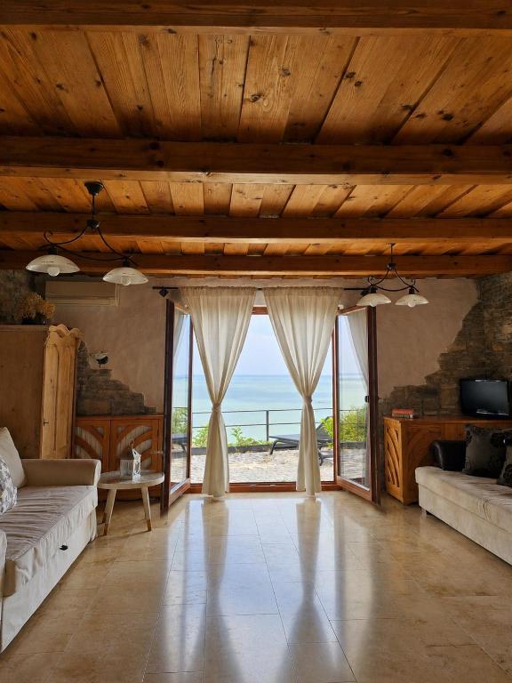a living room with a view of the ocean at Zora Vendégház in Tihany