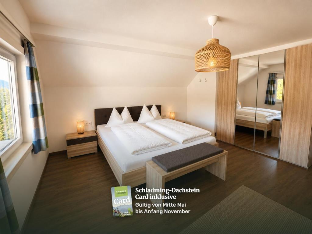 a bedroom with a bed and a mirror at Appartements Luna in Schladming