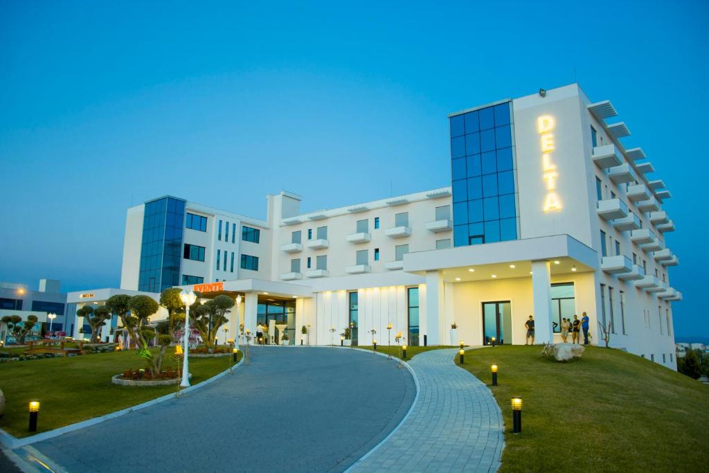 a large white building with a sign on it at Hotel Delta in Durrës