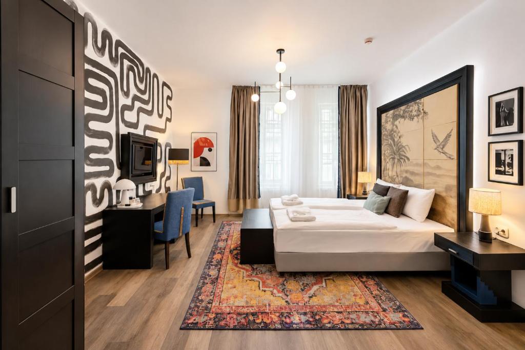 a bedroom with a bed and a desk and a tv at Hotel Ottofiori in Budapest