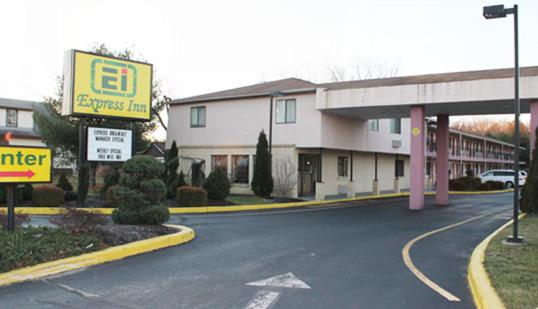 a building with a gas station on a street at Express Inn - Wall in Farmingdale