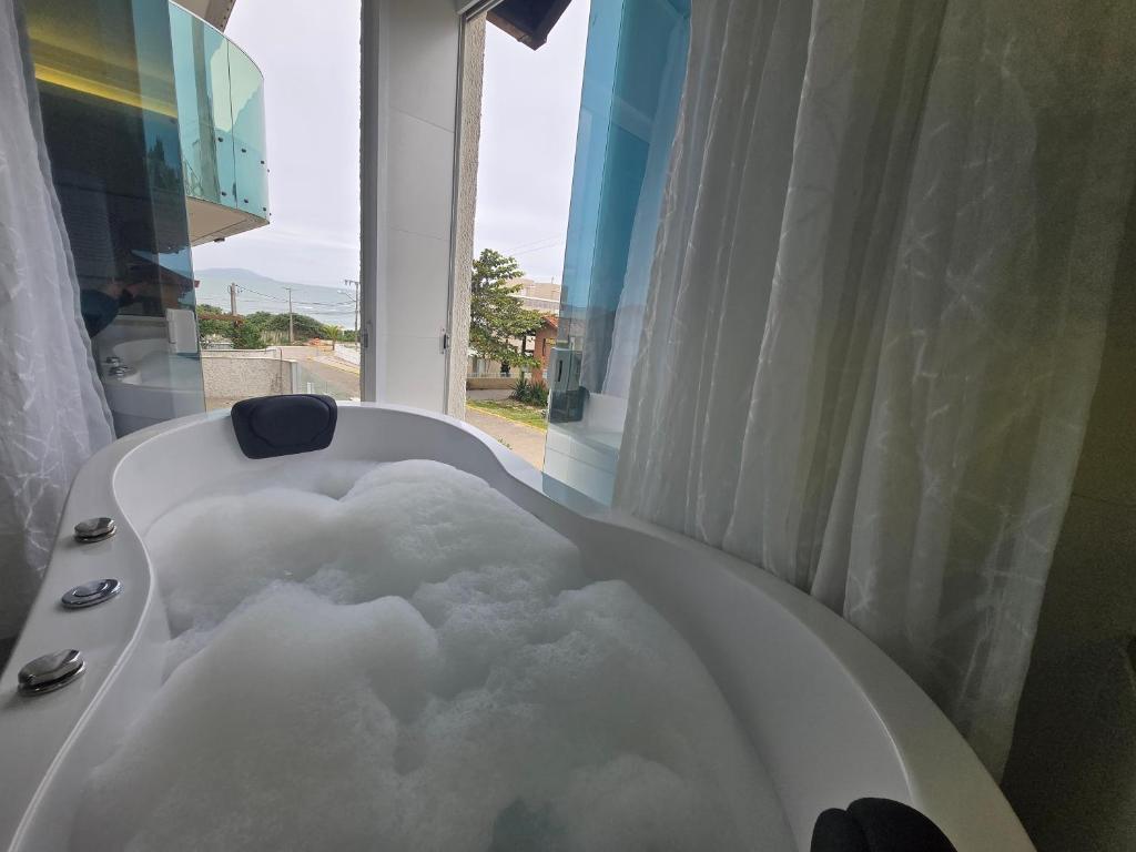 a bath tub filled with snow in a bathroom at Pousada Retiro das Ilhas in Bombinhas