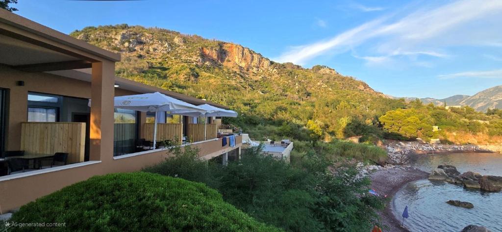 a building with a view of a river and a mountain at Beachfront Blue Panorama in Bar