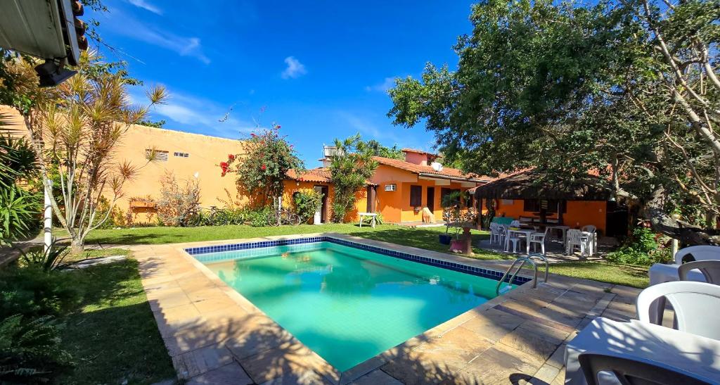 a swimming pool in the yard of a house at Bella vida Geriba suites in Búzios