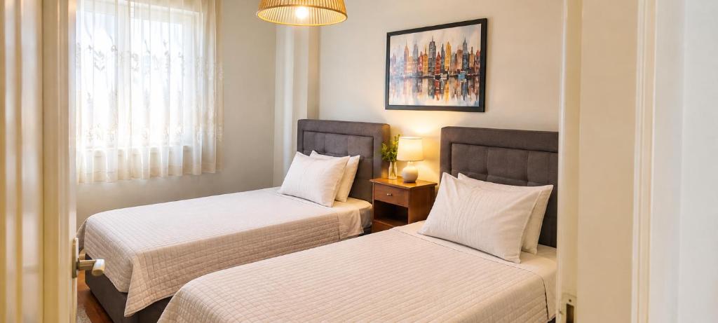 a room with two beds and a window at Alexandra's house in Arta