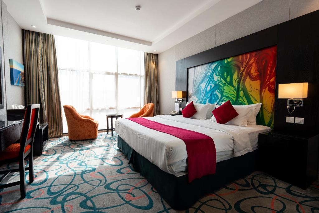 a hotel room with a bed and a large window at فندق الراحة السويسرية Swiss Repose Hotel in Jeddah