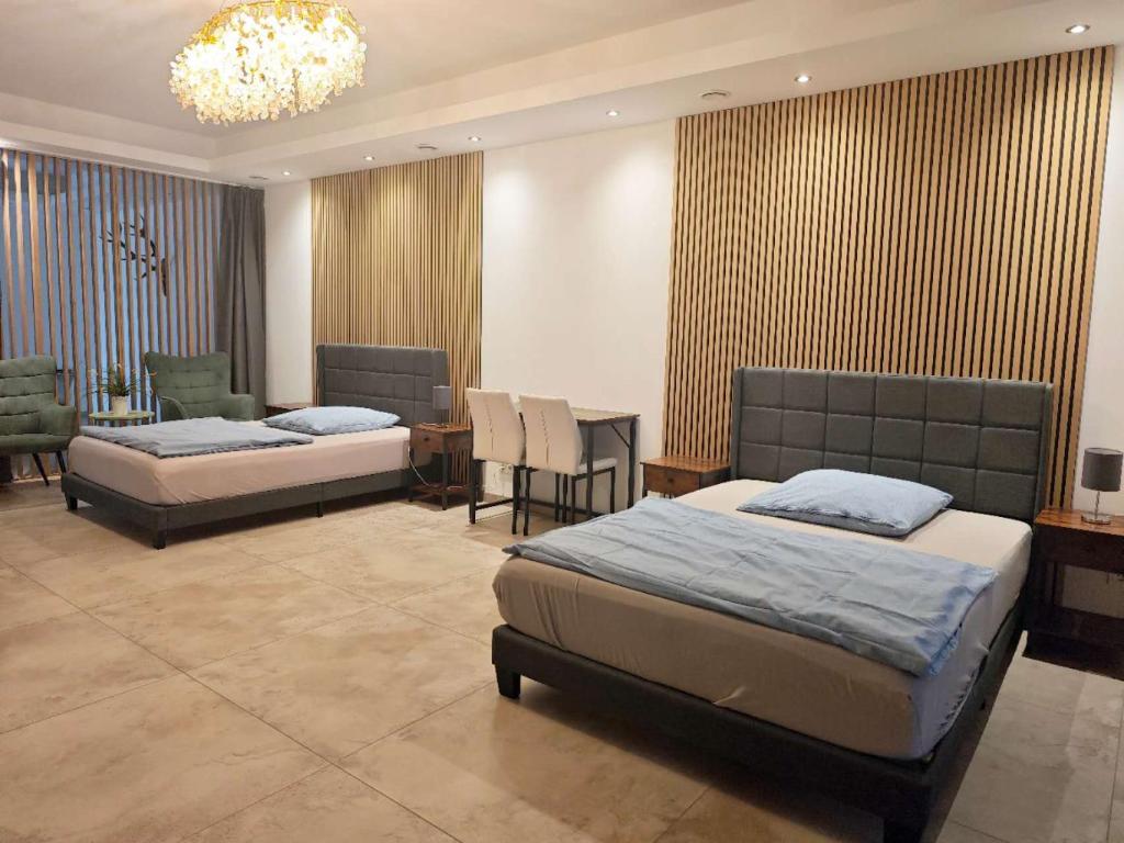 a bedroom with two beds and a table and chairs at Gästehaus Ferienwohnung Wohnung #1 Jülich in Jülich