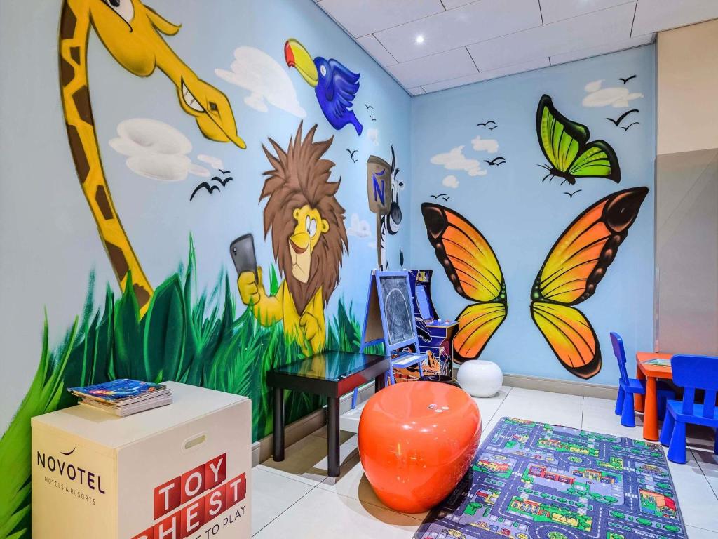 a room with a mural of a lion and butterflies at Novotel Birmingham Centre in Birmingham