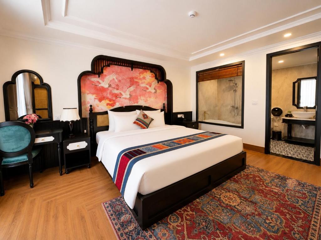 a bedroom with a large bed and a desk at Anara Sapa Hotel & Coffee in Sapa