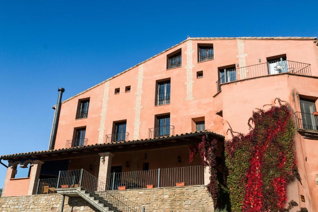a large brick building with flowers growing on it at Hotel Rural La Sal in Salinas de Hoz