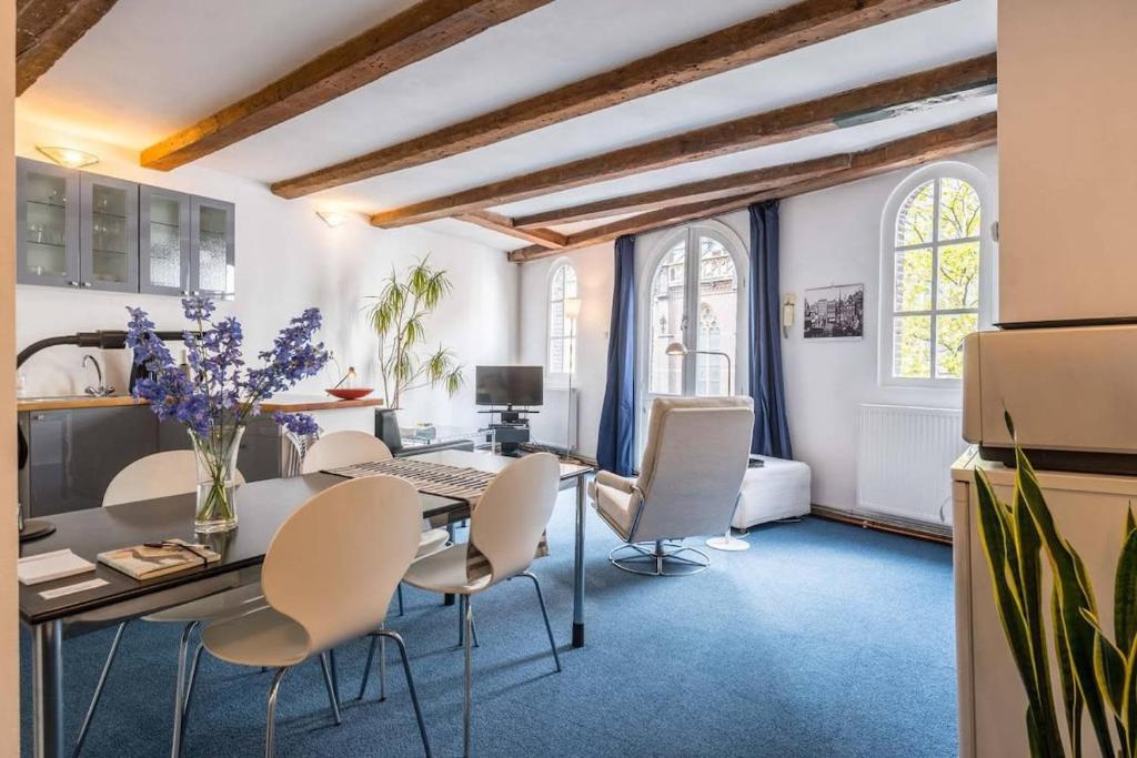 a dining room with a table and chairs at Anny's Warehouse City Centre! in Amsterdam
