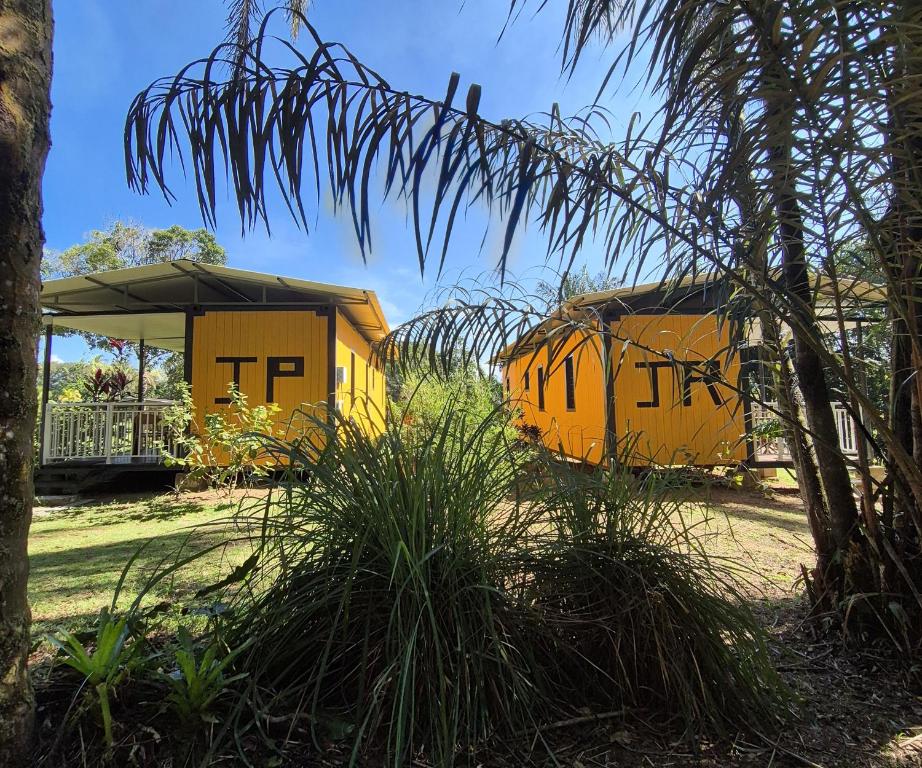 two yellow containers with the words ttp on them at Le Ghirol - Tiny Houses & Nature in Quesnel
