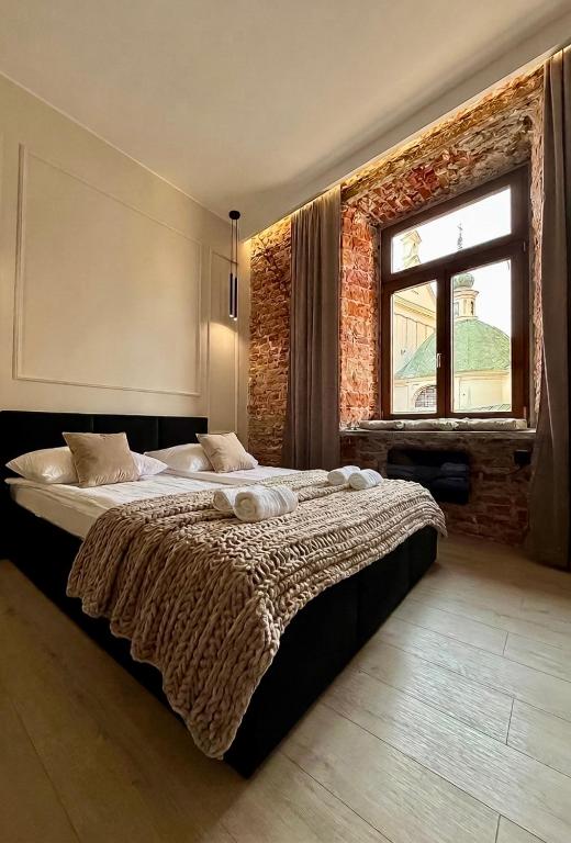 a bedroom with a large bed in front of a window at GRATIA RESIDENCE Lublin in Lublin