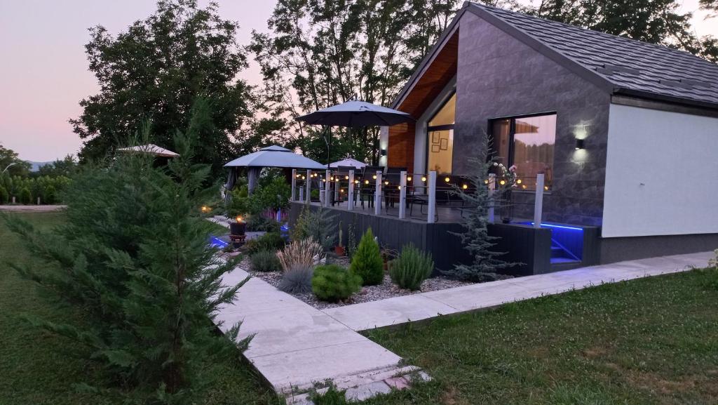 a house with umbrellas and candles in a yard at Chalet Terra Transfăgărășan in Cerbureni