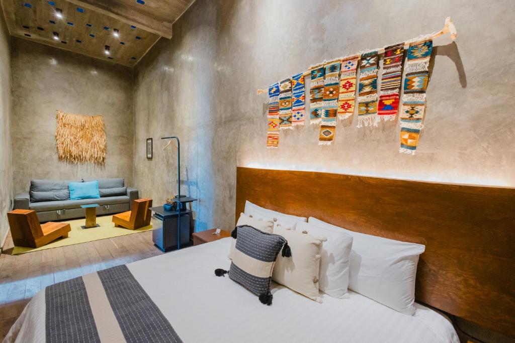 a bedroom with a large bed and a couch at Casa Levonka in Oaxaca City