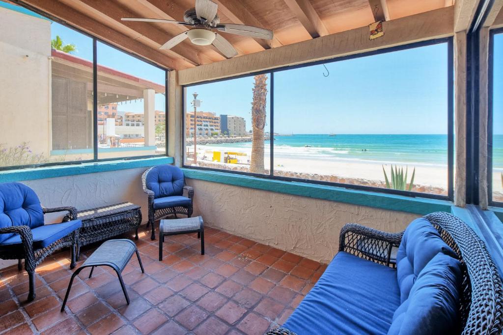 a screened in porch with a view of the beach at Super Beachfront Condo Ground Level on Sandy Beach in Puerto Peñasco