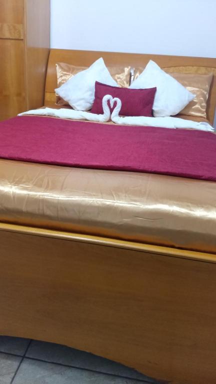 a bed with purple and white pillows on it at Suites in Domingos Martins