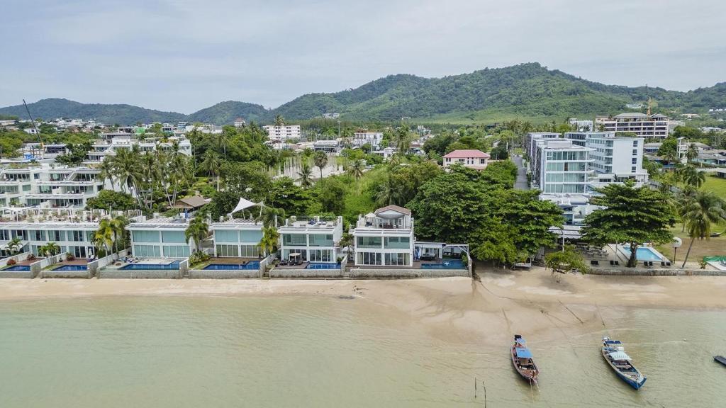 an aerial view of a beach with buildings and boats at Absolute Oceanfront Tara Villa Beachfront 4 Bed in Ban Saiyuan (1)