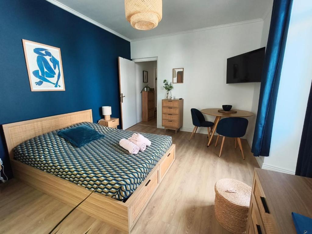 a bedroom with a bed with a teddy bear on it at Logis cosy du centre ville in Aix-les-Bains