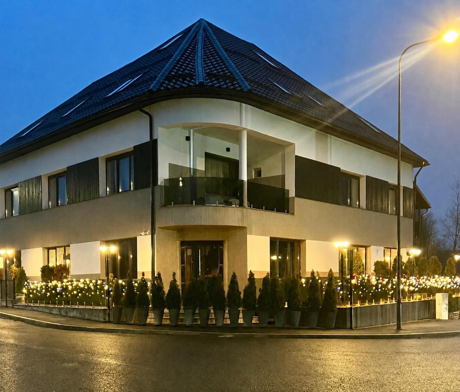 a large white building with a black roof at Casa Braneana in Bran