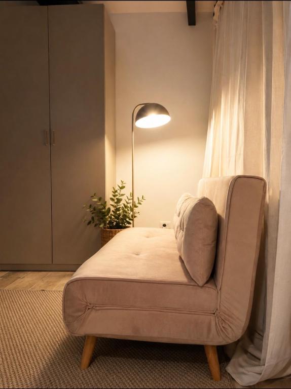 a living room with a chair and a lamp at Vega Suite in Bracciano