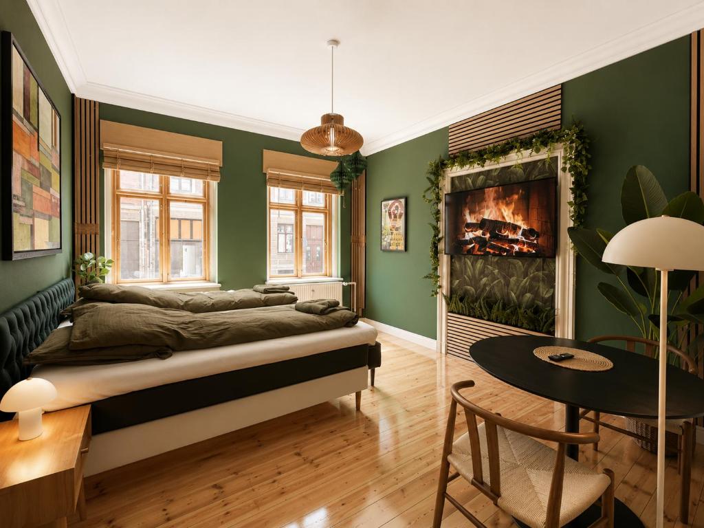 a bedroom with green walls and a bed with a fireplace at Greenbrook Homes - Jungle Suite in Aalborg