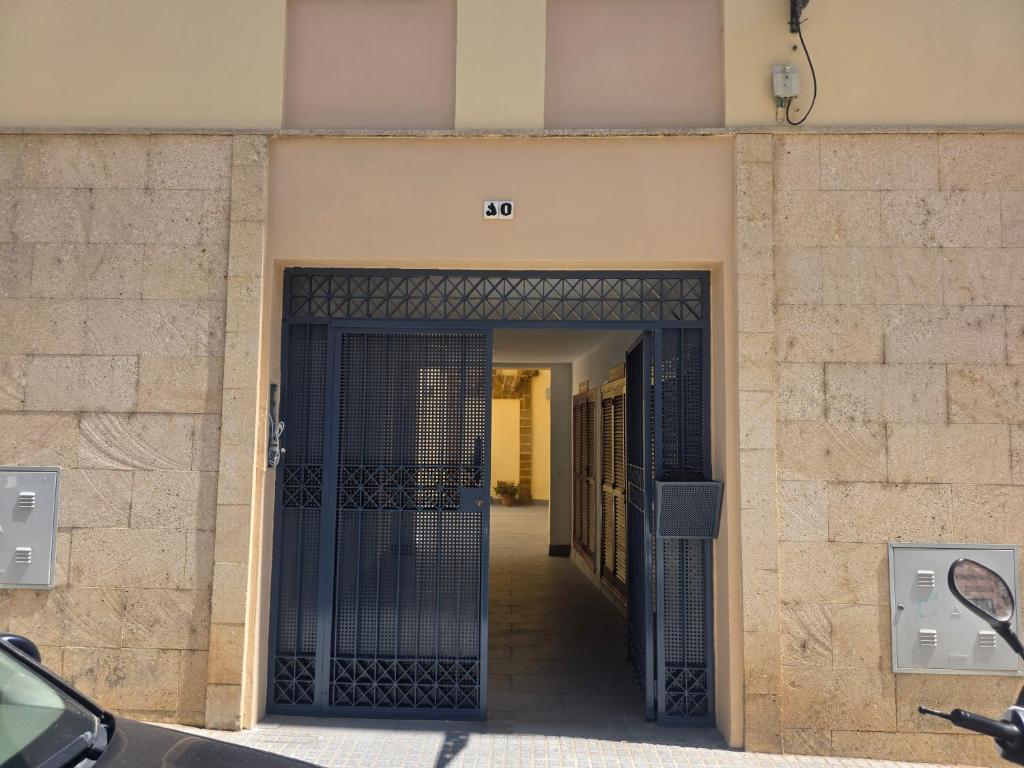an entrance to a building with a black gate at Casa Andrea in Puerto Real