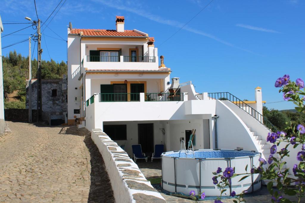 a house with a swimming pool in front of it at Port'Espada Countryhouse in Marvão