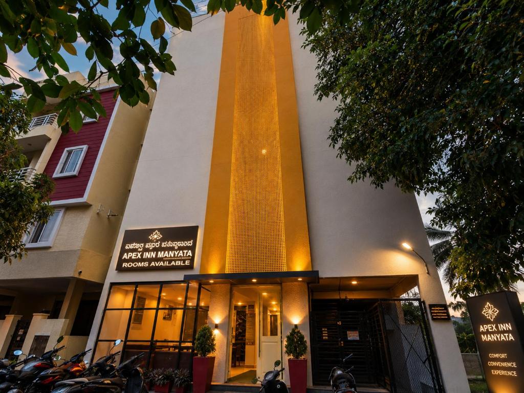 a building with a large tower on the side of it at Apex Inn Manyata in Bangalore