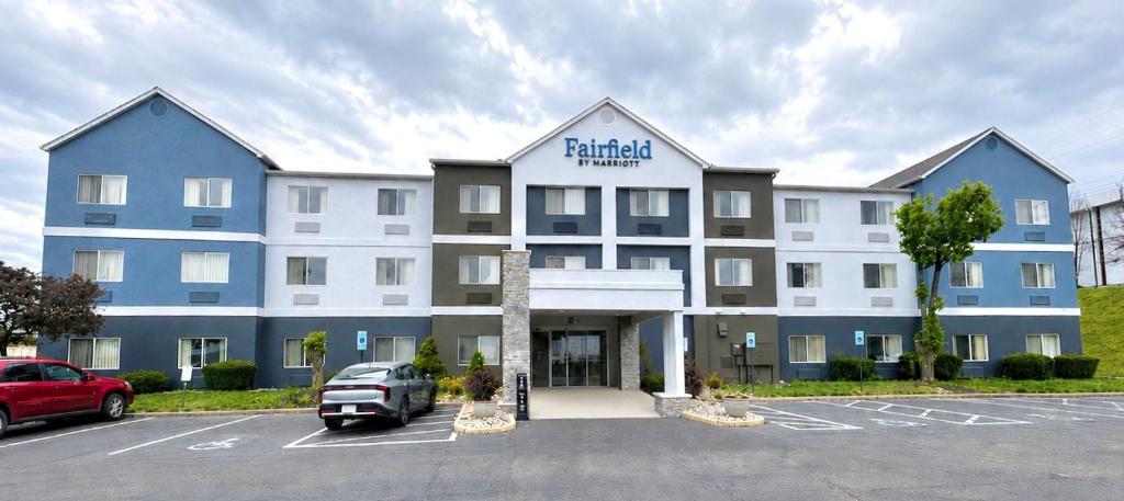 a building with a car parked in a parking lot at Fairfield by Marriott Middletown Monroe in Middletown