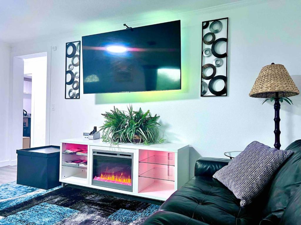 a living room with a couch and a fireplace at Saint Augustine 3BR PetFriendly Fenced Backyard in St. Augustine