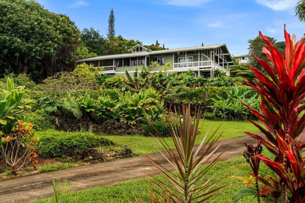 a house in the middle of a garden at Orchid Hale in Kailua-Kona