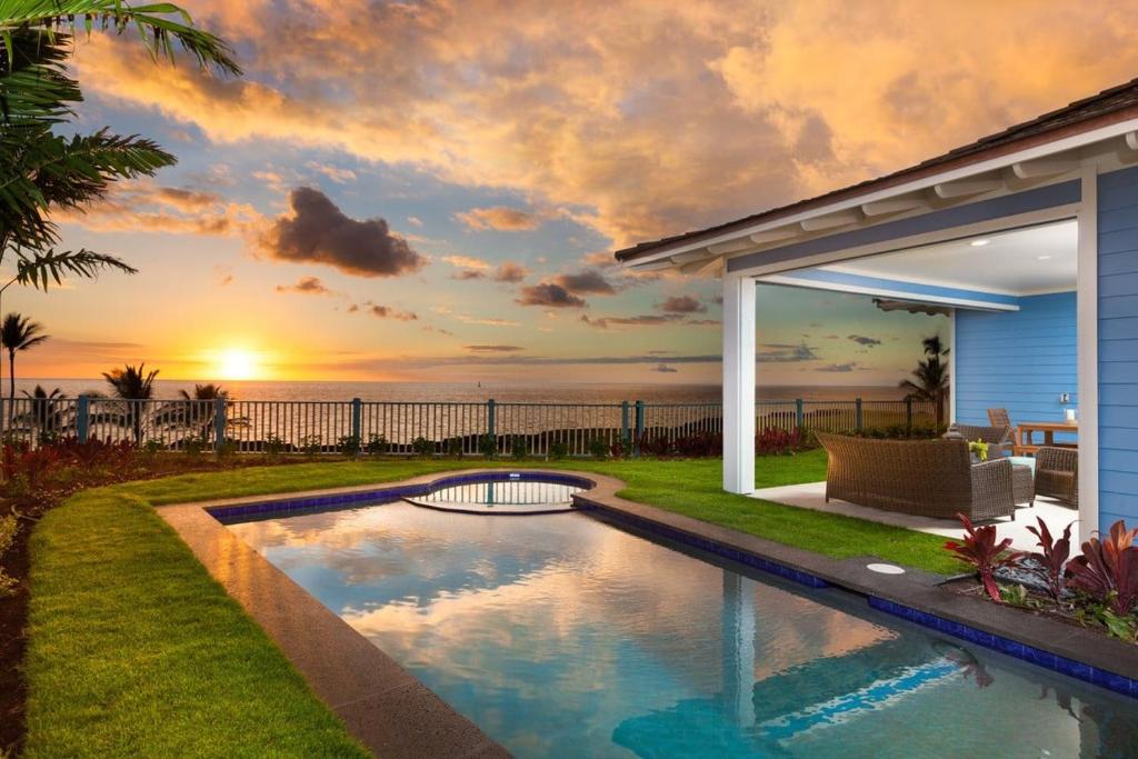 a backyard pool with a view of the ocean at Holua Kai 21 in Kailua-Kona