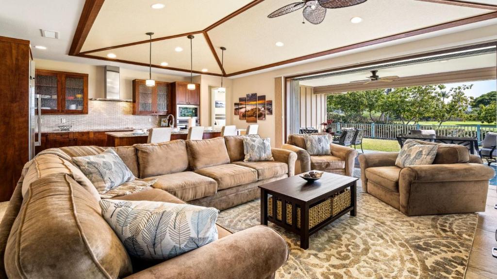 a living room with a couch and a table at Holua Kai 6 in Kailua-Kona