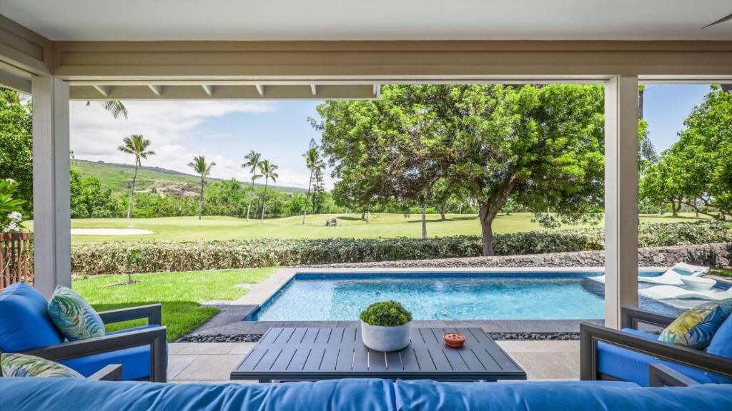 a patio with a swimming pool and a table at Holua Kai 2 in Kailua-Kona