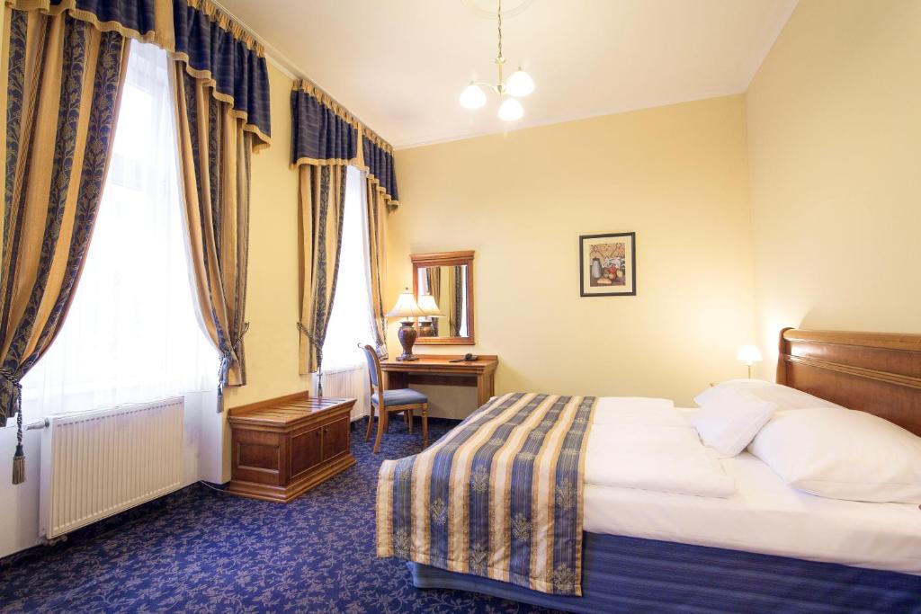 Posteľ alebo postele v izbe v ubytovaní Hotel Ontario