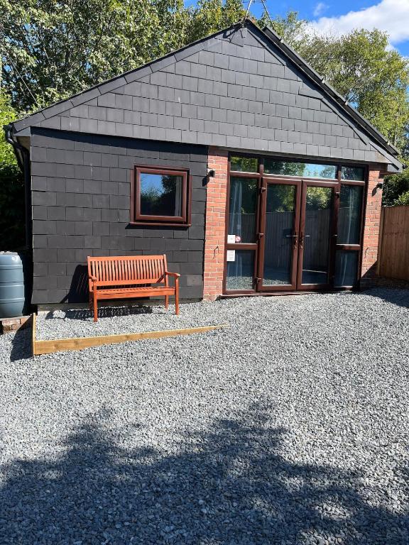 a bench sitting in front of a building at Our Wendy House in Holsworthy