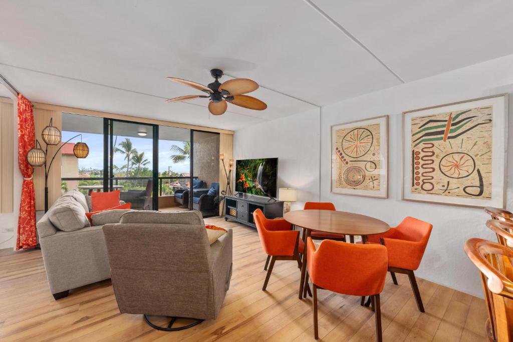 a living room with a couch and a table at Kona Pacific A306 in Kailua-Kona