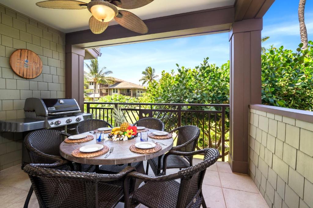 a patio with a table and chairs and a grill at Halii Kai 20F in Waikoloa