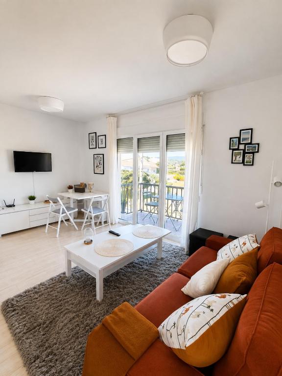 a living room with a couch and a table at Dunas de Corrubedo in Ribeira