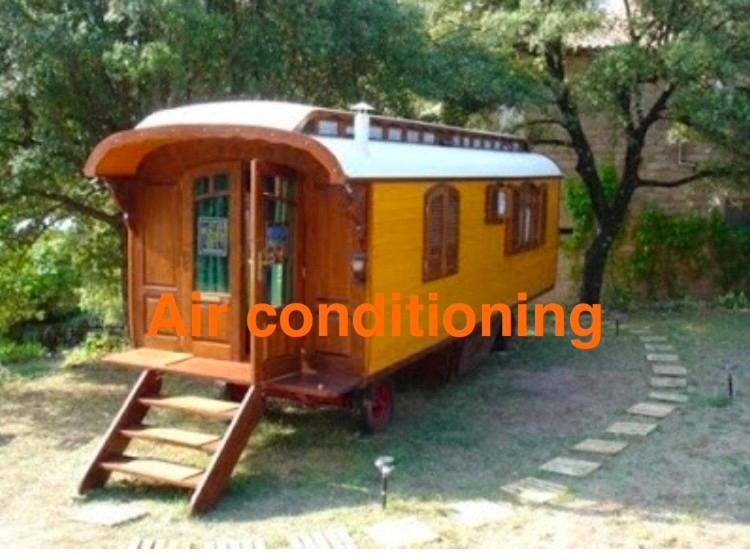 a tiny house sitting on the grass in a yard at Idyllic French farmhouse in Les Assions