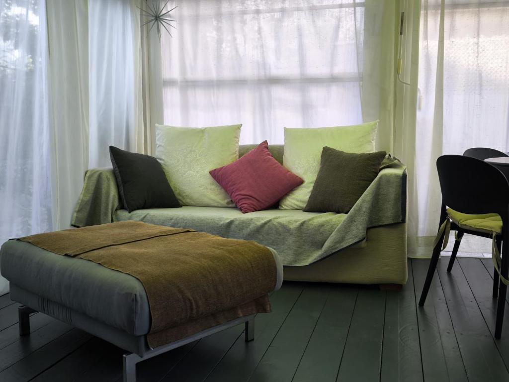 a couch with pillows sitting in front of a window at L'Angolino Nascosto in Senigallia