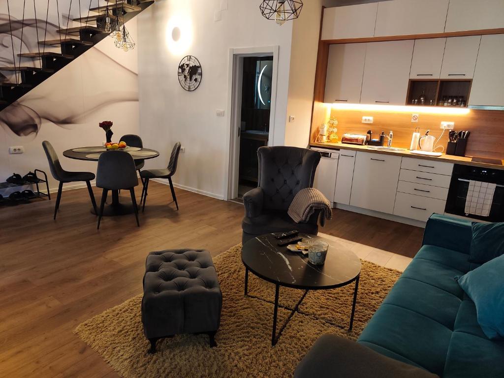 a living room with a couch and a table at Marigold Premium in Novi Sad
