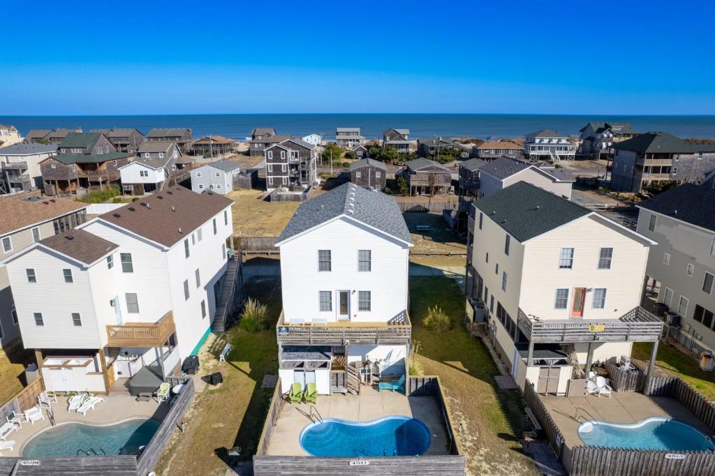 an aerial view of a neighborhood with white houses and the ocean at 6150 - B Groove Inn (formerly Pelican Crest) in Nags Head