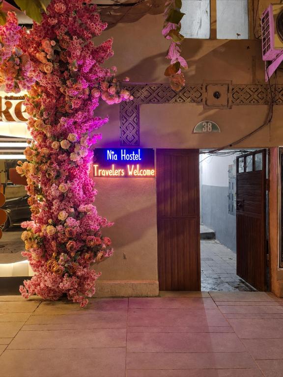 a lobby with a bunch of flowers on a wall at Green Hostel in Yerevan