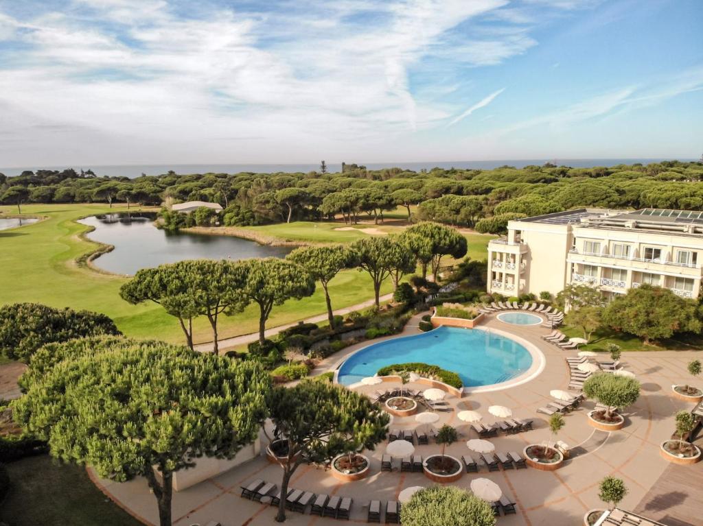 an aerial view of a resort with a pool and trees at Kimpton Quinta da Marinha by IHG in Cascais
